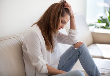 Sad depressed thoughtful young woman feeling bad at home