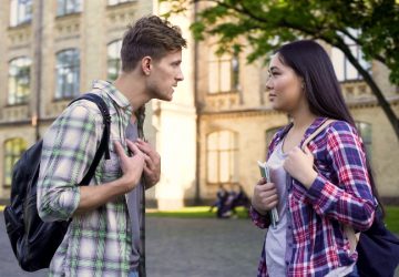 couple arguing in front of building